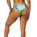 Casa Nayar Coastal String Bikini Bottom — back view, teal tropical all-over print with Casa Nayar wordmark at waistband